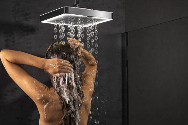 Lady washing her hair in the unique BubbleSpa air-powered shower.