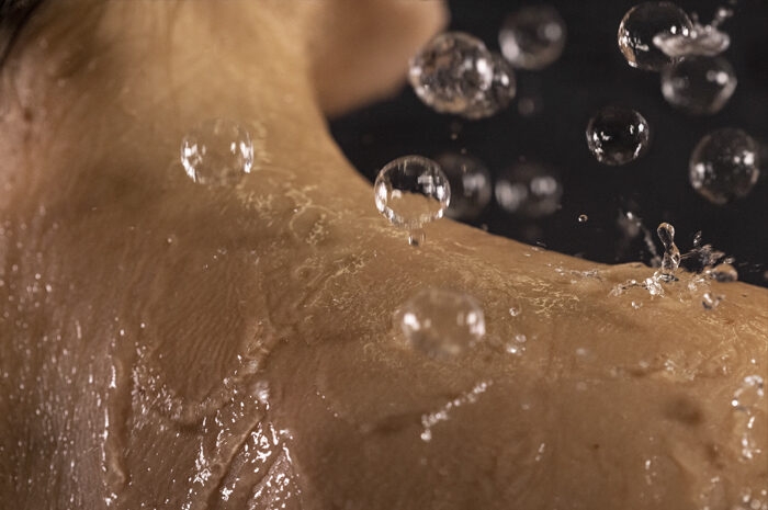 Close-up of BubbleSpa air-powered shower bubbles on the shoulder.